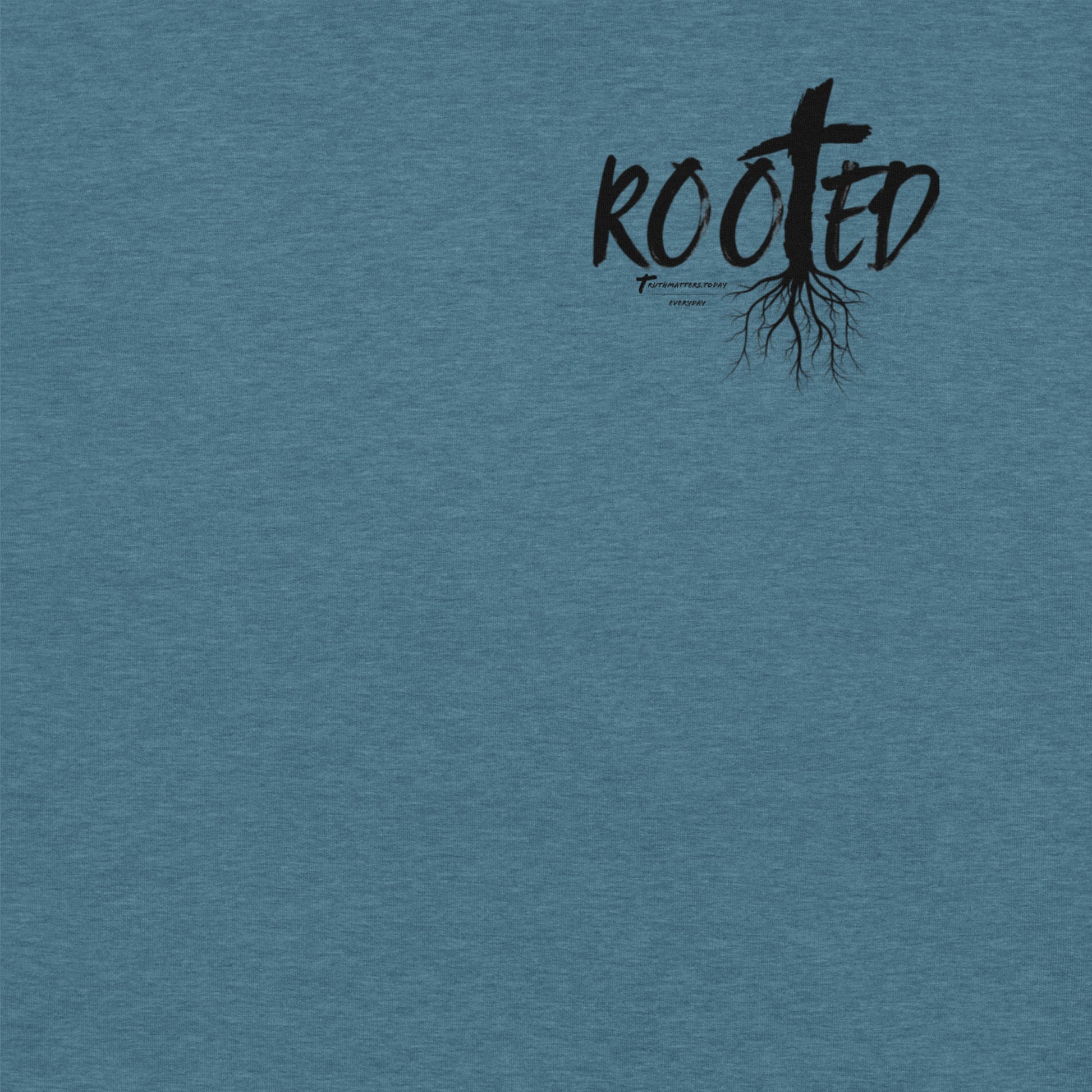 Front of Rooted Christian t-shirt in deep teal with cross and tree roots design and Colossians 2:6-7 scripture.