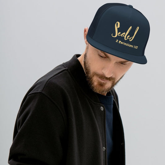 Man wearing a navy blue trucker with Sealed 2 Corinthians 1:22 printed. 