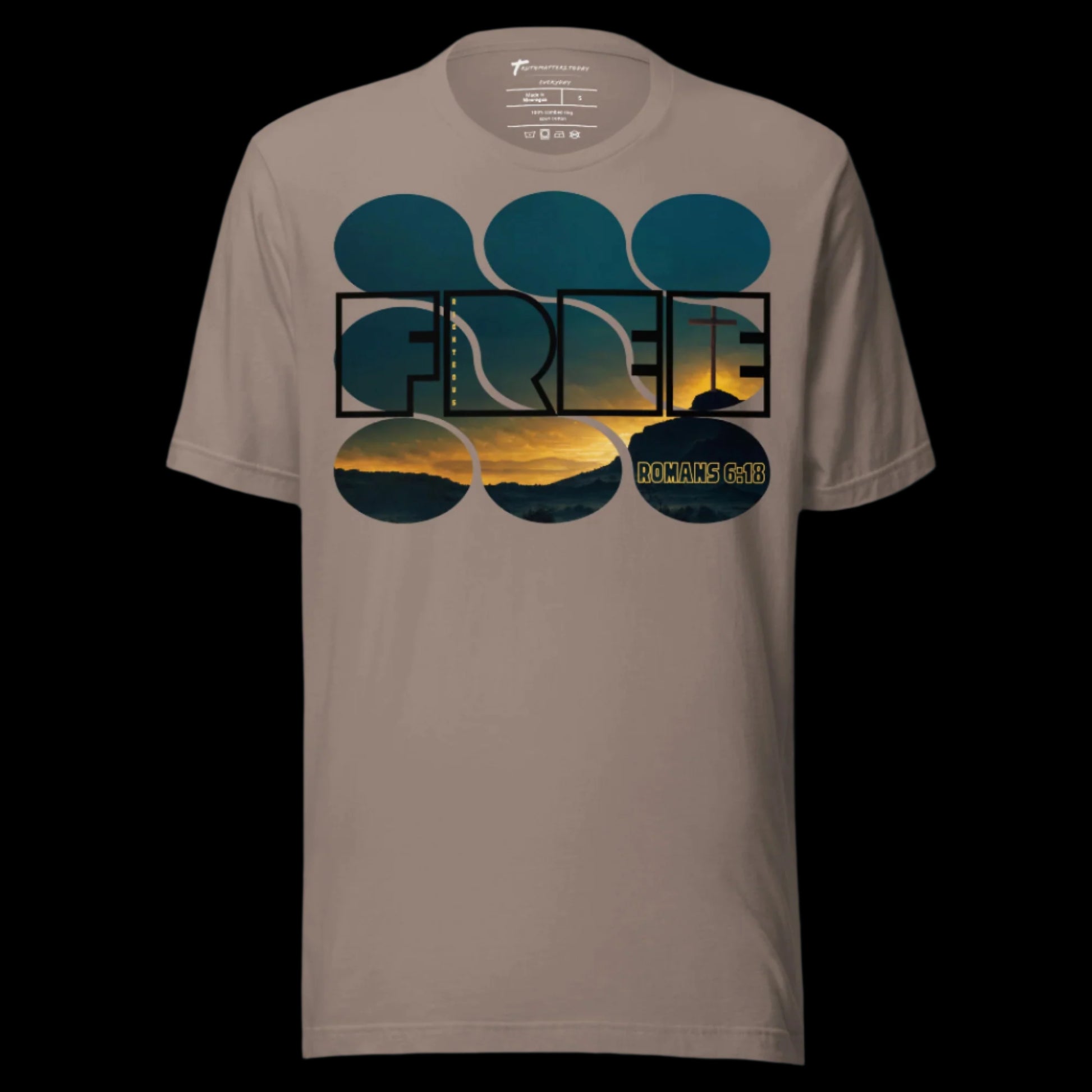 Truth Matters’ Romans 6:18 T-Shirt front with ‘FREE’, ‘Righteous’, and sunset cross on soft cotton in Pebble.