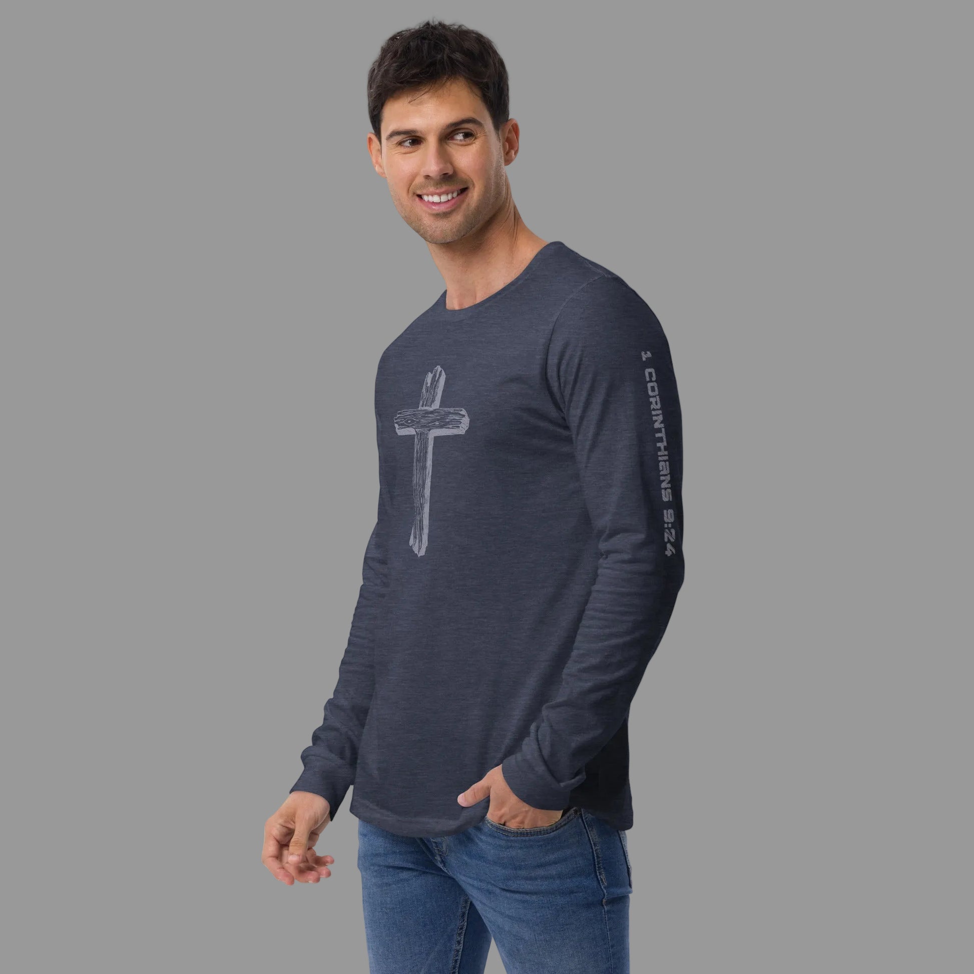 Side-front view of man in Truth Matters Run the Race long sleeve tee, Heather Navy, cross on chest and 1 Corinthians 9:24 down the sleeve