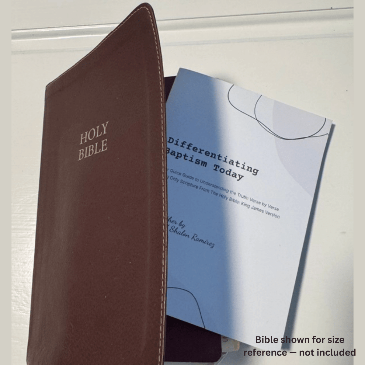 Differentiating Baptism Today printed 5x7 KJV pocket scripture reference shown beside a brown leather Holy Bible for size reference (Bible not included), by Sean and Shalon Ramirez