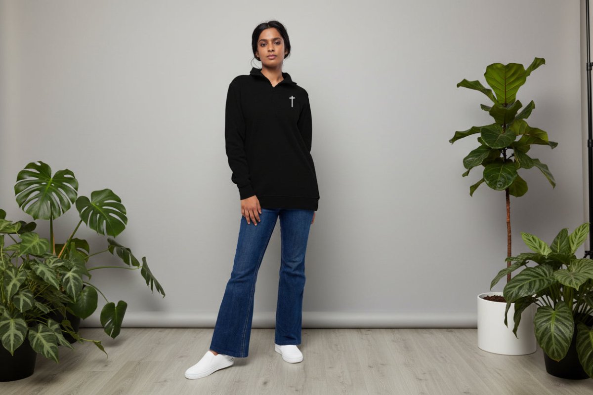 Model wearing Elevate Christian quarter-zip pullover in black in relaxed fit lifestyle setting